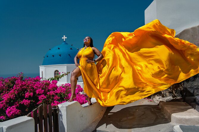 Flying Dress Photoshoot in Oia Private entry to Blue Dome - The flying dress effect: how the assistant and wind create the look