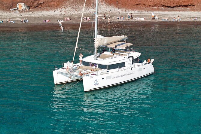Luxury Santorini Catamaran Cruise: Lunch, BBQ, Drinks, Transfers - Sailing past Red Beach, White Beach, Indian Rocks, and Akrotiri Lighthouse