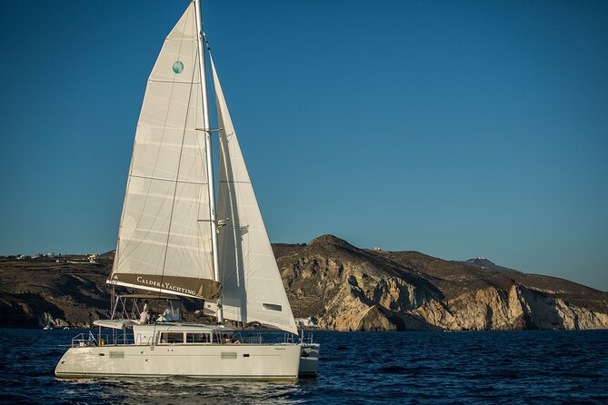 Santorini Caldera Gold Day Cruise with BBQ on board and Open Bar - White Beach, the Akrotiri lighthouse pass, and the Black Mountain area