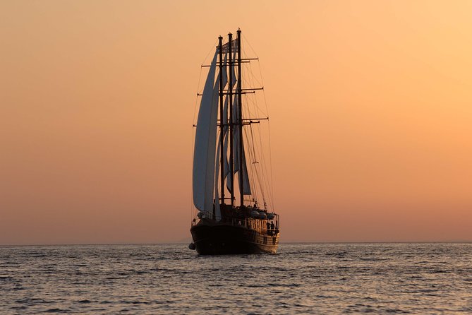Santorini Caldera Sunset Sailing Cruise with Dinner and Wine - Stop 3: Thirassia Bay dinner on board with complimentary wine