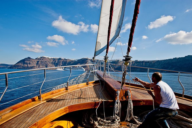 Santorini Caldera Sunset Sailing Cruise with Dinner and Wine - Stop 4: Oia sunset from the caldera, with wine in hand