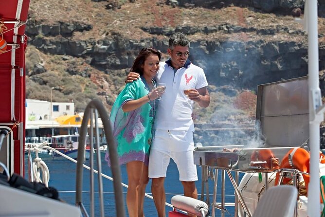 Santorini Cruise on Catamaran with BBQ & Open Bar - Stop 1: Santorini Volcano Hot Springs Swim, Black Rocks, and Warm Water