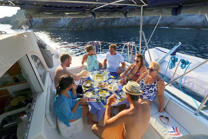 Santorini Full Day Catamaran Private Cruise incl. Meal, Drinks & Free Transport - Red Beach and White Beach: Volcanic Colors Plus Snorkeling Time