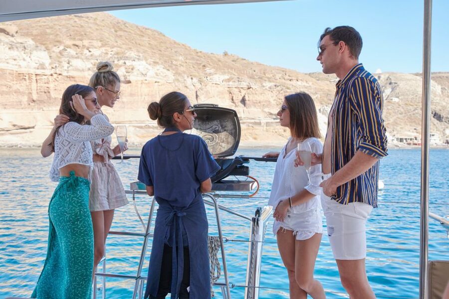 Santorini Gold Catamaran Cruise with Snorkel, BBQ & Open Bar - Crew Energy, Music, and Staying Comfortable On a Catamaran