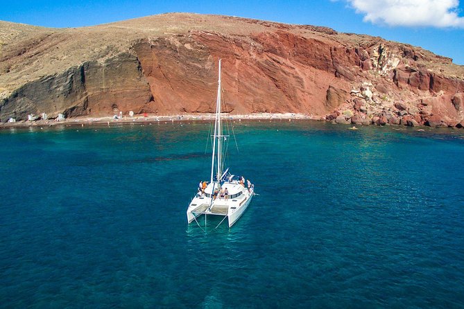 Santorini Half Day Catamaran Private Cruise incl. Meal, Drinks & Free Transport - Getting started at Vlychada Marina and the black-sand approach