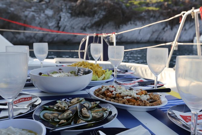 Santorini Half Day Catamaran Private Cruise incl. Meal, Drinks & Free Transport - Mesa Pigadia Beach: the quiet-south choice for black rock lovers