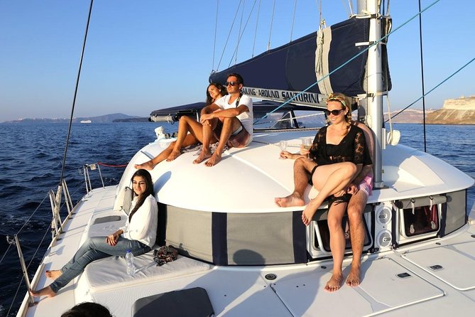 Santorini Half Day Catamaran Private Cruise incl. Meal, Drinks & Free Transport - Red Beach by boat: volcanic colors and easy photos