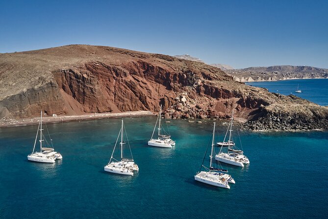 Santorini: Luxury Catamaran Cruise with Fresh Fish BBQ & Drinks - Mesa Pigadia’s black sand and quiet-water feeling