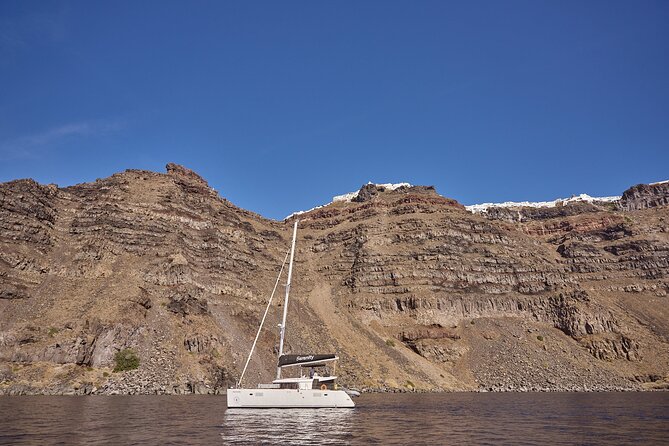 Santorini Oia: Luxury Sunset Cruise with Fresh Fish BBQ & Drinks - Thirassia swim stop: turquoise water and a calmer pace