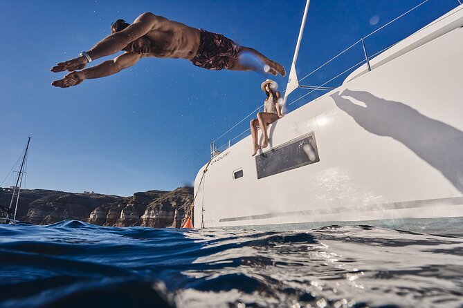 Santorini Oia: Luxury Sunset Cruise with Fresh Fish BBQ & Drinks - Nea Kameni: lava colors and floating in salty water