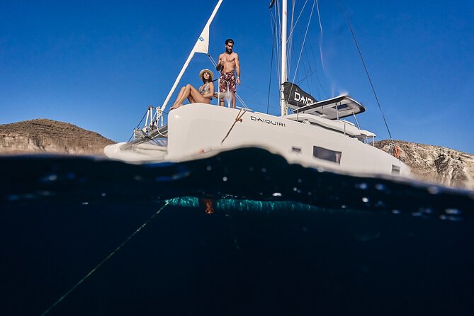 Santorini Oia: Luxury Sunset Cruise with Fresh Fish BBQ & Drinks - Mesa Pigadia Beach: a secluded black beach only reached by boat