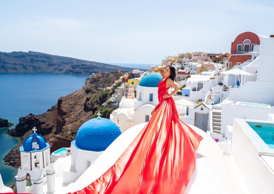 Santorini: Private Flying Dress Photoshoot with Pickup - Oia for blue domes and classic caldera viewpoints