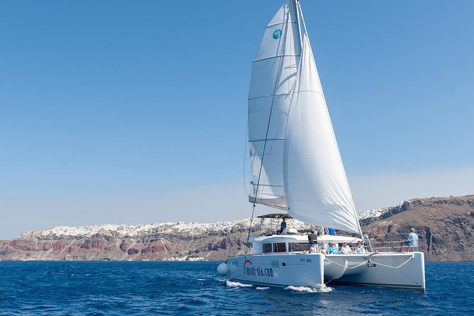 Santorini Small-Group Catamaran Sailing Trip(BBQ,drinks, transfer) - The Caldera Cruise Portion: lighthouse views and volcanic-side sailing