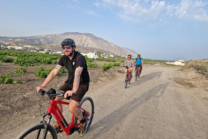 Santorini Small Group Guided E-bike Tour & Local Tomato Museum - Perissa Black Sand Beach, fast but memorable