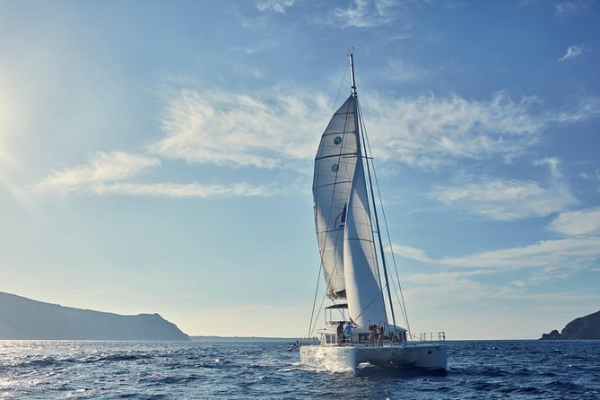 Santorini Sunset Luxury Sailing Catamaran Cruise with BBQ, drinks, transfer - Red Beach Stop: Colorful Swims in About 30 Minutes