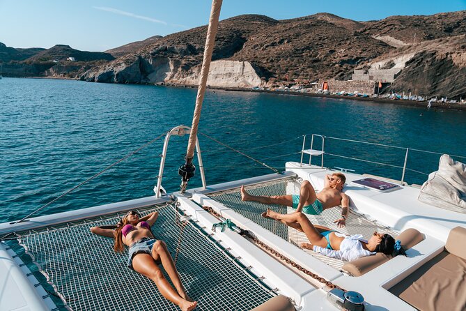 Santorini Sunset Sailing Cruise: Dinner, BBQ, Open Bar, Transfers - Sailing highlights: White Beach, Indian Rocks, and the Venetian Lighthouse